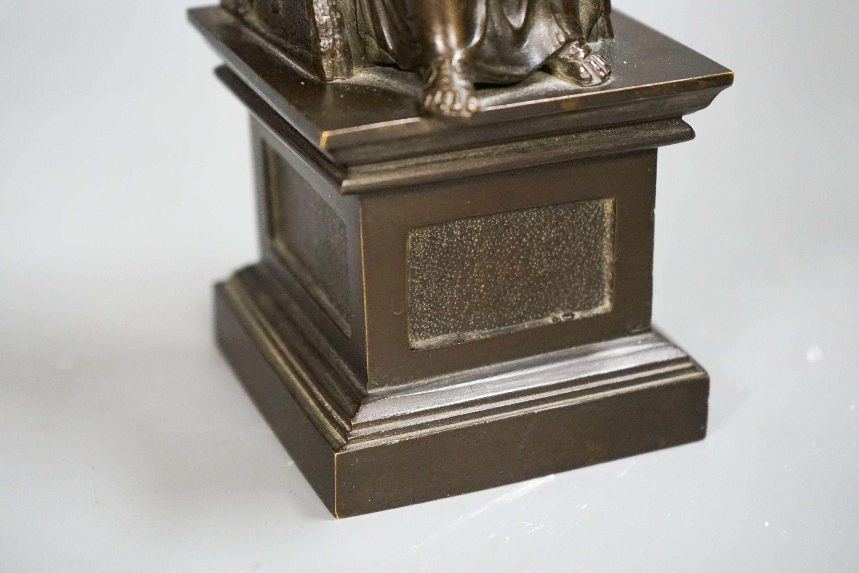 A late 19th century bronze figure of St. Peter seated on a throne, 22cm